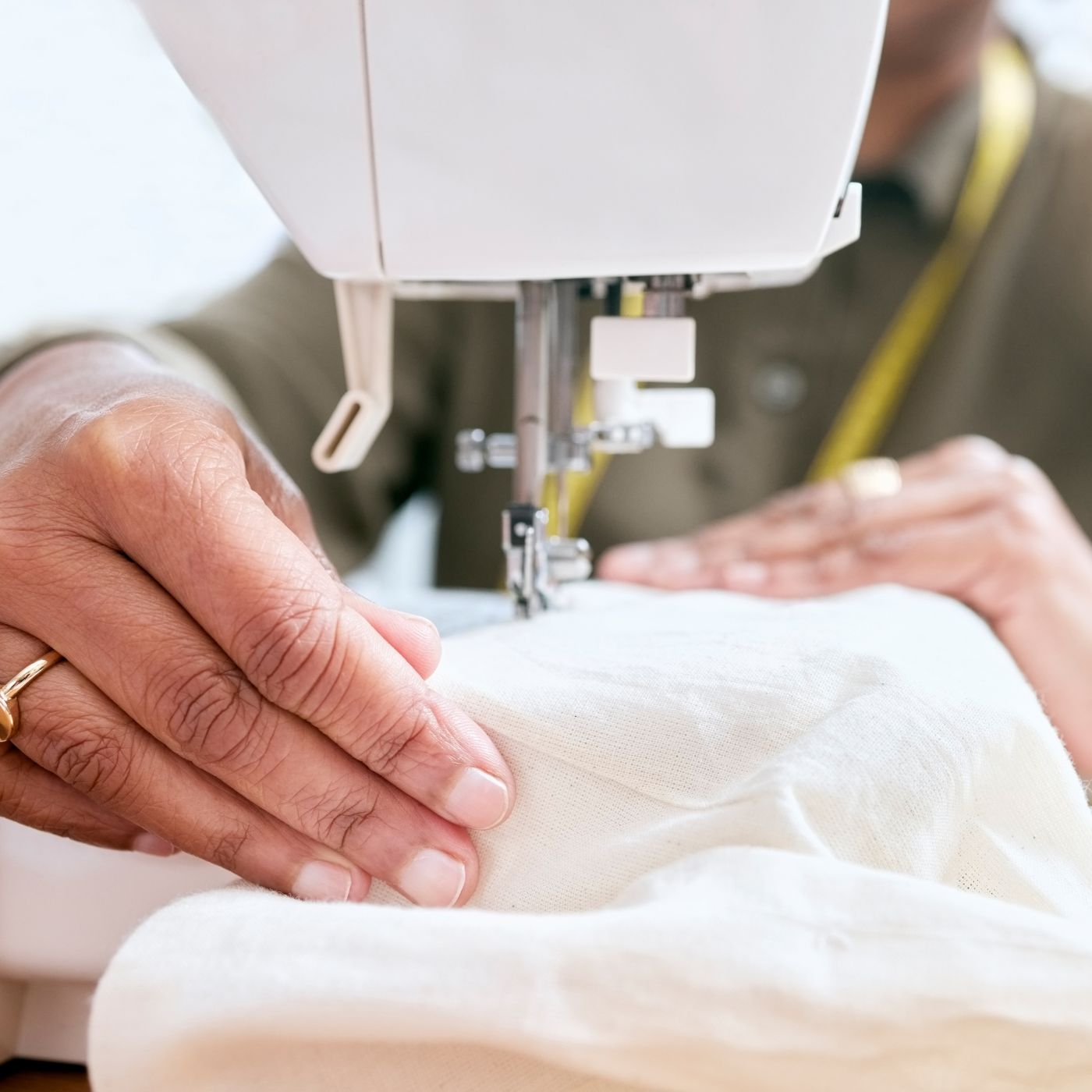 A sewing machine in action creating a nerdy button up shirt with various geeky motifs.