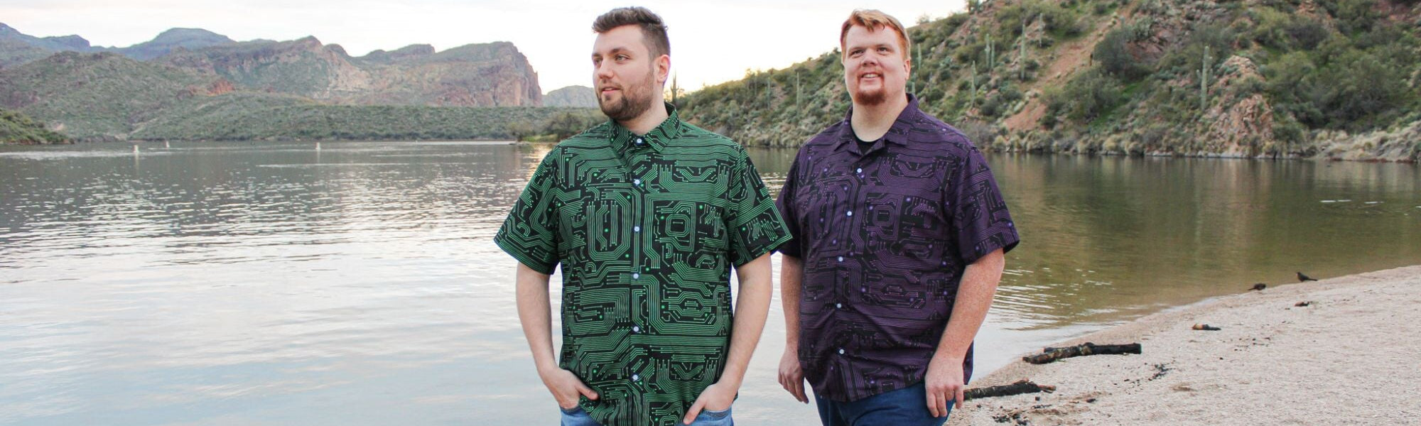 Two men wearing cool tropical button-up shirts with a unique print of computer circuit boards. These geeky shirts are perfect for men who love technology and want to show off their inner geek.