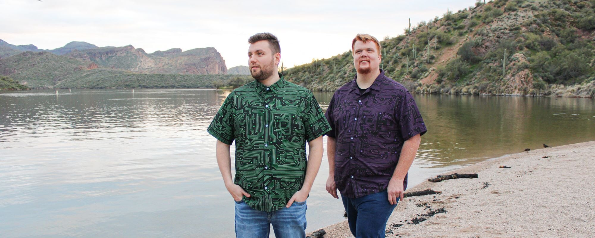 Two men wearing cool tropical button-up shirts with a unique print of computer circuit boards. These geeky shirts are perfect for men who love technology and want to show off their inner geek.