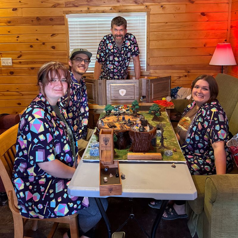 Four people in a cabin playing Dungeons & Dragons wearing geeky dnd button ups from Geek Tropical.