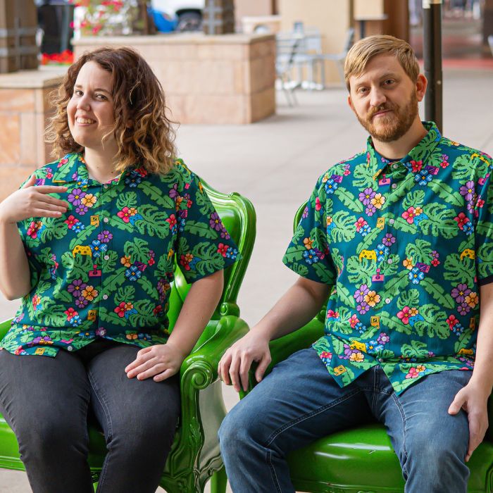 two people sitting in chairs wearing tropical Hawaiian shirts with arcade and video game symbols